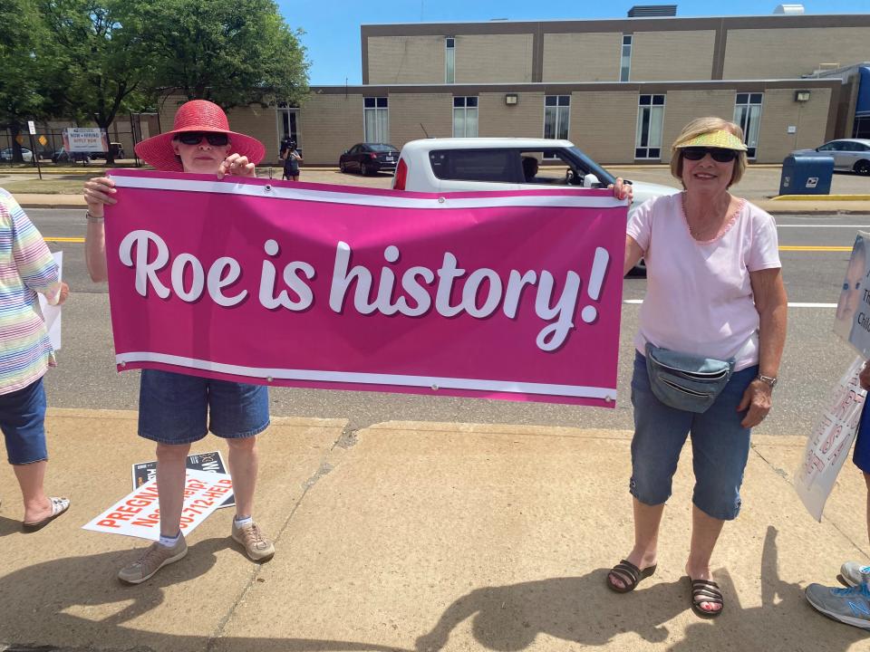 Victory Petry and Tish Bell, of North Canton, stand on the sidewalk outside Planned Parenthood on Saturday.