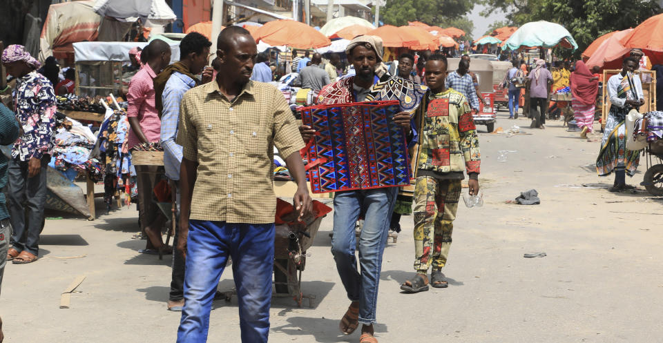 Somalis without facemasks visit the Bakara Market in Mogadishu, Somalia on Wednesday Dec. 2, 2020. As richer countries race to distribute COVID-19 vaccines, Somalia remains the rare place where much of the population hasn't taken the coronavirus seriously. Some fear that’s proven to be deadlier than anyone knows. (AP Photo/Farah Abdi Warsameh)