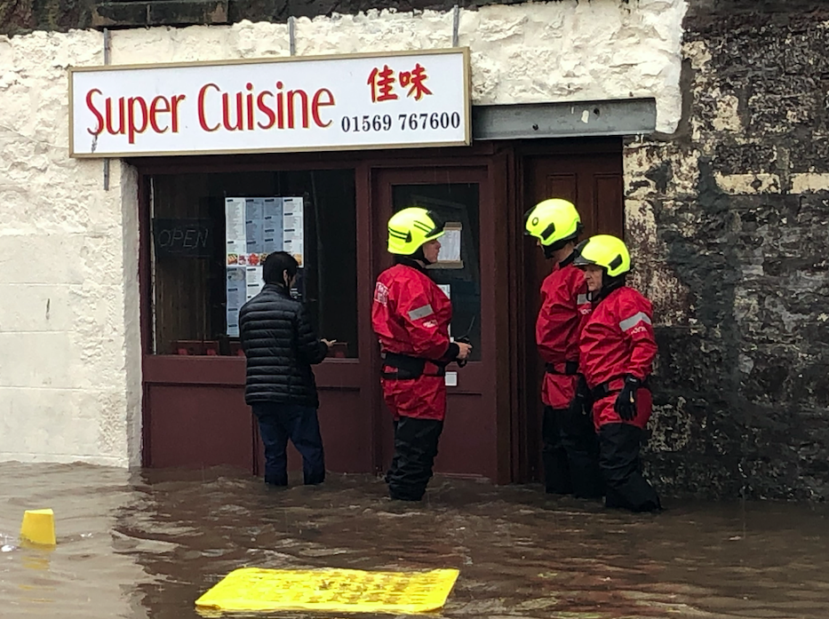 A takeaway in Stonehaven is surrounded by floodwater after a night of torrential rain.