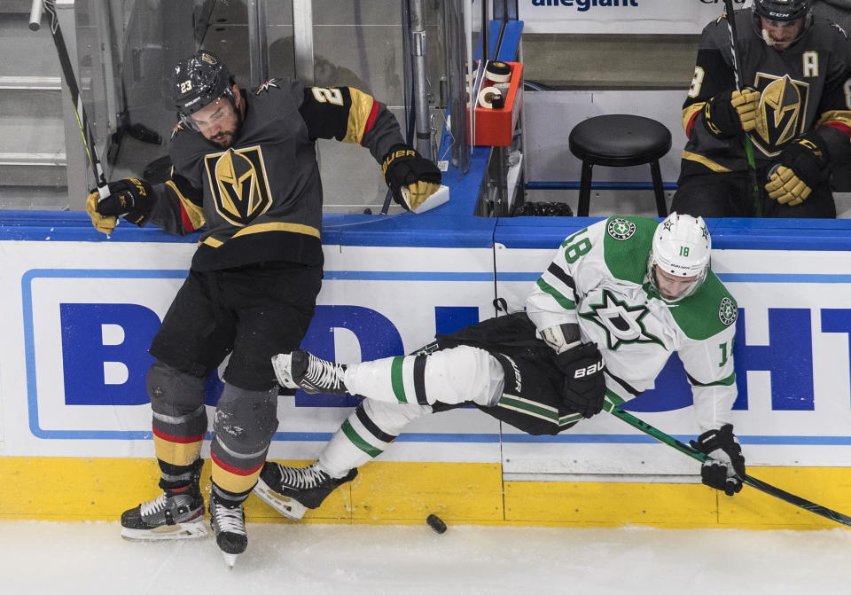 Dallas Stars' Jason Dickinson (18) is checked by Vegas Golden Knights' Alec Martinez (23) during the first period of Game 2 of the NHL hockey Western Conference final, Tuesday, Sept. 8, 2020, in Edmonton, Alberta. (Jason Franson/The Canadian Press via AP)