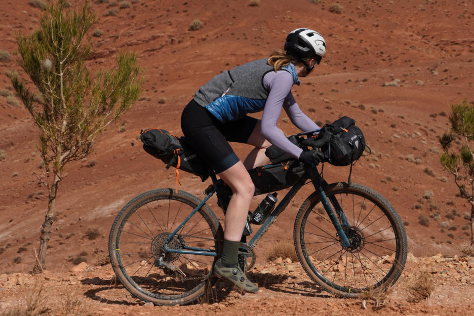 Female cyclist riding with smartphone for navigation