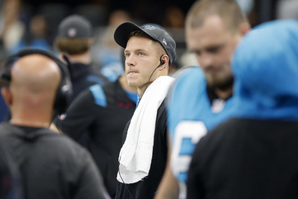 FILE - Carolina Panthers running back Christian McCaffrey watches play from the sideline against the Dallas Cowboys in the first half of a NFL football game in Arlington, Texas, Sunday, Oct. 3, 2021. Carolina Panthers running back Christian McCaffrey and quarterback Sam Darnold showed up for practice on Wednesday, Nov. 3, 2021, in full pads. However, their status for Sunday's game against the New England Patriots remained very much up in the air.(AP Photo/Michael Ainsworth, File)