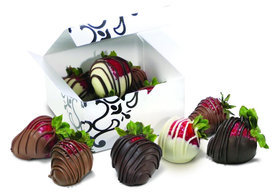 Chocolate covered strawberries on offer, with milk, dark, and white chocolate flavors for sale.