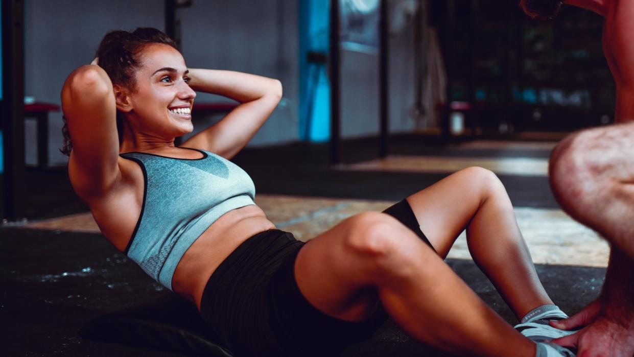  a photo of a woman doing butterfly crunches 