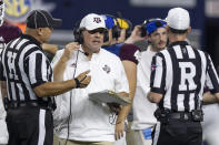 Texas A&M coach Jimbo Fisher confers with head line judge Chad Green, left, and referee Ken Williamson during the second half of the team's NCAA college football game against Arkansas on Saturday, Sept. 24, 2022, in Arlington, Texas. Texas A&M won 23-21. (AP Photo/Brandon Wade)