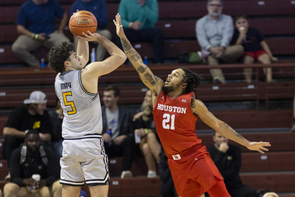 Houston's Emanuel Sharp (21) defends against Towson's Christian May (5) during the first half of an NCAA college basketball game in the Charleston Classic in Charleston, S.C., Thursday, Nov. 16, 2023. (AP Photo/Mic Smith)