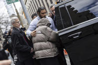 British billionaire Joe Lewis, covered in a jacket, leaves Manhattan Federal court, Thursday, April 4, 2024, in New York. Lewis, whose family trust owns the Tottenham Hotspur soccer club, will not spend any time in prison after he pleaded guilty to insider trading and conspiracy charges in New York, a federal judge said Thursday. (AP Photo/Jeenah Moon)