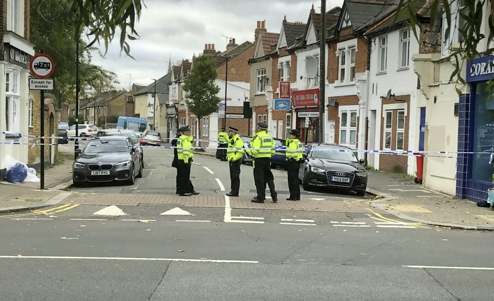 Police and floral tributes at the murder scene in Brentford, west London, November 13, 2021.  An 82-year-old woman repeatedly stabbed during a knife frenzy in which a 20-year-old man was killed is a retired barmaid, according to horrified local residents.  SeeSWNS story SWNNfrenzy.  The pensioner, named locally as Betty Walsh, suffered multiple stab wounds when a man armed with a knife went on the rampage outside a kebab shop in Brentford, west London.  She was taken to hospital where she remains in a 