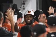 Baltimore Orioles' Kelvin Gutierrez is greeted by teammates in the dugout after hitting a two-run home run against Texas Rangers starting pitcher Jordan Lyles during the seventh inning of a baseball game, Saturday, Sept. 25, 2021, in Baltimore. (AP Photo/Terrance Williams)