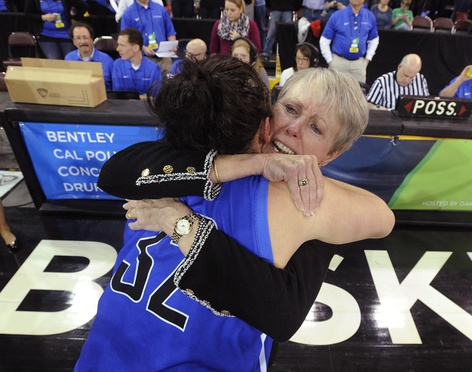 FILE - Bentley coach Barbara Stevens hugs Jacqui Brugliera after Bentley defeated West Texas A&M 73-65 to win the NCAA Division II women's basketball tournament championship in Eria, Pa., in this Friday, March 28, 2014, file photo. Kobe Bryant was a major proponent of women’s basketball, and his posthumous induction into the Basketball Hall of Fame this weekend will be alongside three legends of the women’s game in Kim Mulkey, Tamika Catchings and Barbara Stevens.(AP Photo/Erie Times-News, Jack Hanrahan) MAGS OUT TV OUT