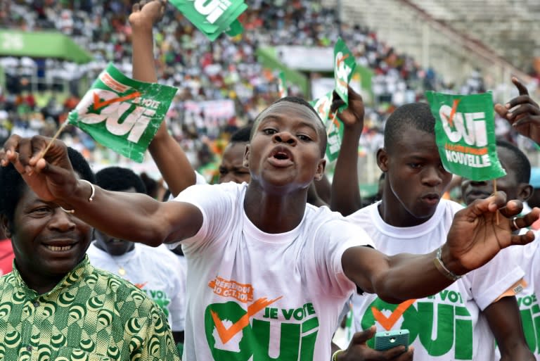 People with placards reading 'Referendum October 30, 2016 - I vote yes' cheer during a rally organised by Ivory Coast's president Alassane Ouattara, at the Felix Houphouet-Boigny stadium in Abidjan, on October 22, 2016