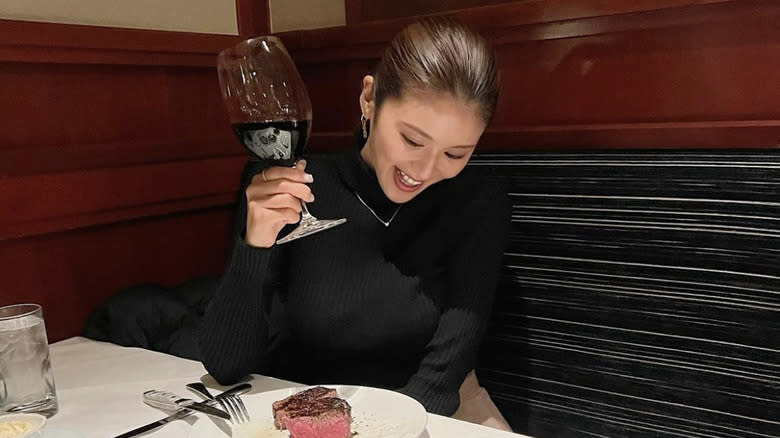 woman drinking wine at Fleming's