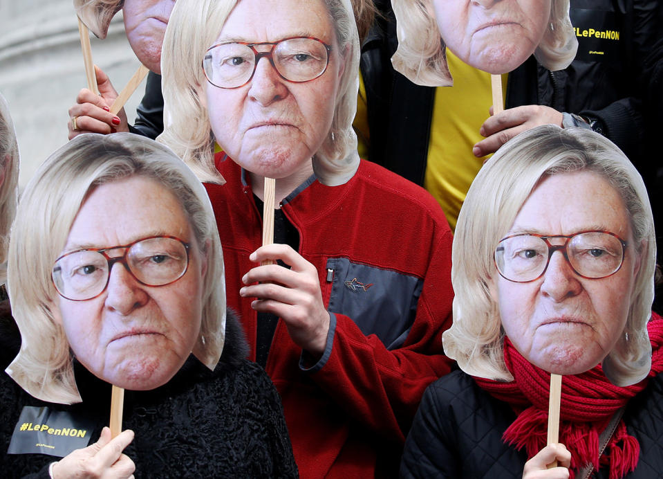Activists wearing masks of Jean-Marie Le Pen