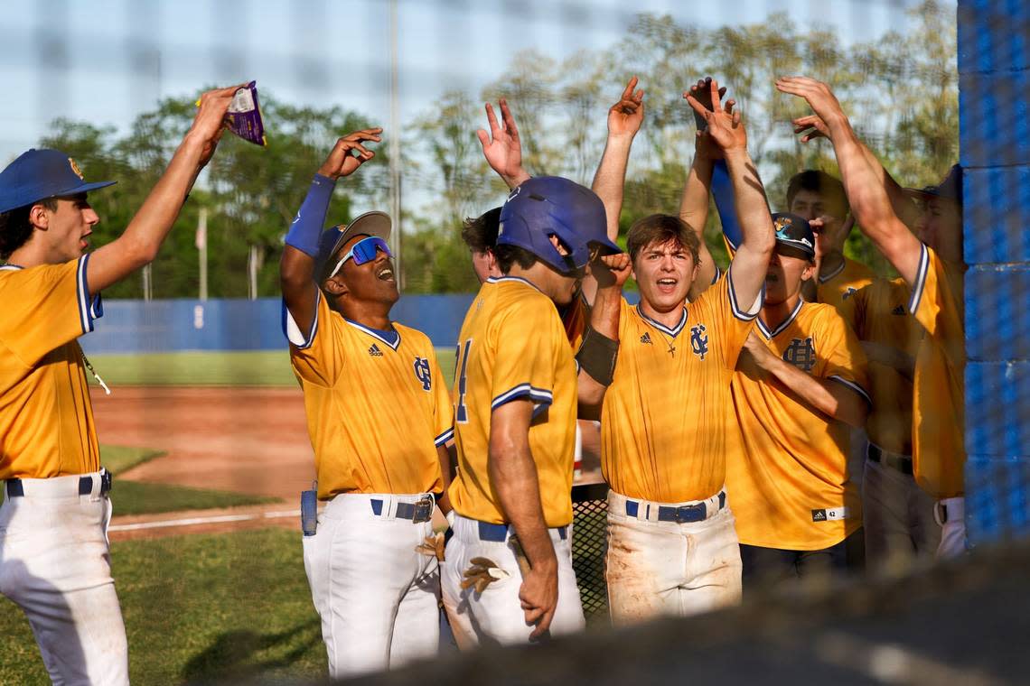 Henry Clay’s Giancarlo Gonzalez (center) celebrates scoring against Scott County with his teammates during their game at Henry Clay High School on Thursday.