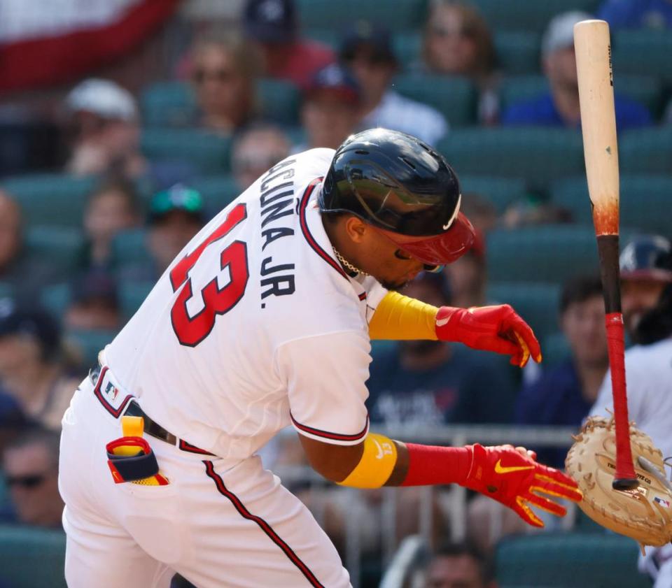 Atlanta Braves Ronald Acuna Jr. reacts after being hit with a pitch in the third inning of a baseball game against the Miami Marlins on Saturday, May 28, 2022, in Atlanta. (AP Photo/Bob Andres)