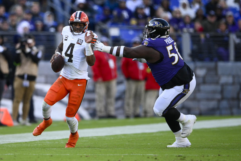 Cleveland Browns quarterback Deshaun Watson runs past Baltimore Ravens defensive tackle Michael Pierce during the first half on an NFL football game Sunday, Nov. 12, 2023, in Baltimore. (AP Photo/Nick Wass)