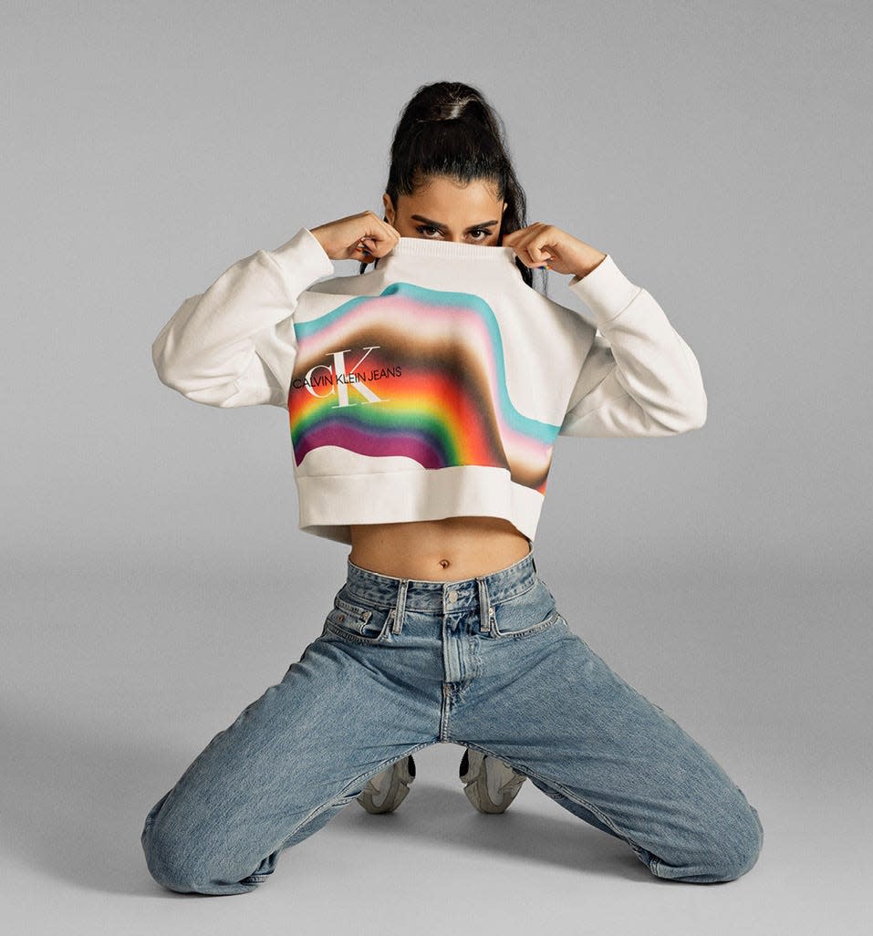 Gia Woods in CK Pride Warped Stripe Monogram Logo Sweatshirt.