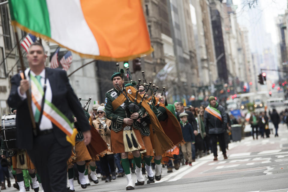 FILE - In this Saturday, March 16, 2019, file photo, bagpipers and others march up Fifth Avenue during the St. Patrick's Day Parade in New York. The New York City St. Patrick’s Day Parade has been postponed for the first time in its 258-year history because of coronavirus concerns, Gov. Andrew Cuomo announced Wednesday, March 11, 2020. (AP Photo/Mary Altaffer, File)