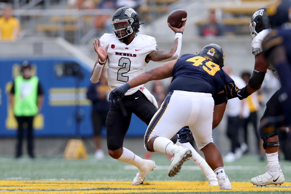 UNLV quarterback Doug Brumfield throws against California defensive lineman Darius Long (49) during the second half of an NCAA college football game in Berkeley, Calif., Saturday, Sept. 10, 2022. (AP Photo/Jed Jacobsohn)