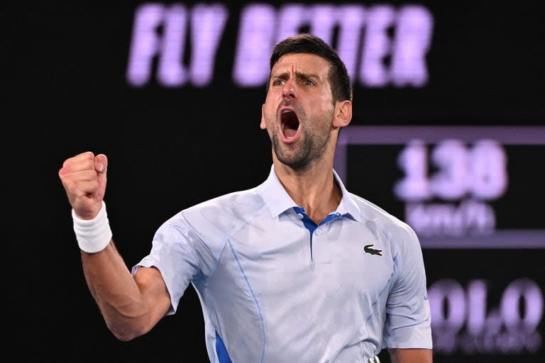 Serbia's Novak Djokovic celebrates after winning the third set against Croatia's Dino Prizmic during their men's singles match on day one of the Australian Open tennis tournament in Melbourne on January 14, 2024. (Photo by WILLIAM WEST / AFP) / -- IMAGE RESTRICTED TO EDITORIAL USE - STRICTLY NO COMMERCIAL USE --