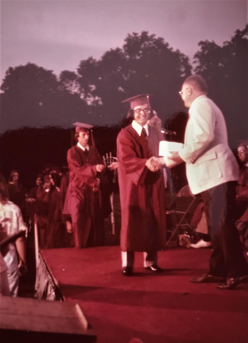 An Oak Ridge High School graduation photo where Zafer Malazgirt is receiving his diploma from Oak Ridge High School Principal James Schott.