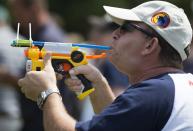 A competitor takes aim with a customised pea shooter during the 2014 World Pea Shooting Championship in Witcham, southern England July 12, 2014. The annual competition has been held in the village since 1971 and attracts participants from across the globe.