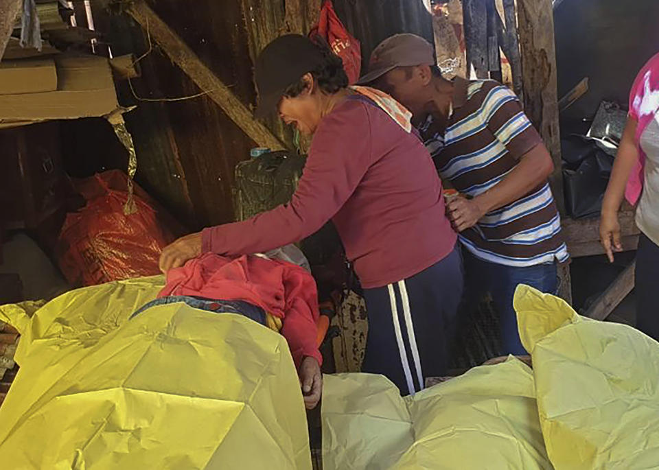 Relatives grieve as they look at one of the victims of a deadly road accident at Boljoon town, Cebu province, central Philippines Friday, July 19, 2019. A truck carrying more than two dozen villagers, mostly ecstatic grade schoolers on their way to a school festival, lost control Friday on a downhill road and flipped on its side, leaving several students and an adult companion dead in the central Philippines, police said. (AP Photo)