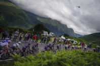 The pack climbs during the seventeenth stage of the Tour de France cycling race over 178.4 kilometers (110.9 miles) with start in Muret and finish in Saint-Lary-Soulan Col du Portet, France, Wednesday, July 14, 2021. (AP Photo/Daniel Cole)