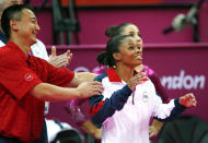 <p>Douglas is held by coach Liang Chow (L) as she reacts to the result of the women’s individual all-around gymnastics final on August 2, 2012. (Brian Snyder/Reuters) </p>