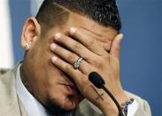 Seattle Mariners' Felix Hernandez covers his face as he becomes emotional during a news conference, Wednesday, Feb. 13, 2013, in Seattle. Hernandez signed a seven-year contract with the Mariners that makes him the highest-paid pitcher in baseball. The new deal will be worth $175 million. (AP Photo/Elaine Thompson)