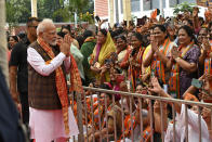Indian Prime Minister Narendra Modi is welcomed at the Bharatiya Janata Party headquarters, where he was felicitated a day after the women's reservation bill was passed by the Indian Parliament in New Delhi, Friday, Sept. 22, 2023. India’s Parliament has approved landmark legislation that reserves 33% of the seats in its powerful lower house and in state legislatures for women to ensure more equal representation, ending a 27-year impasse over the bill amid a lack of consensus among political parties. (AP Photo)