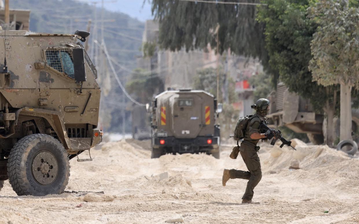 An Israeli soldier operates during a raid in the Nur Shams camp for Palestinian refugees near the city of Tulkarem