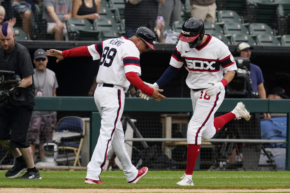 Chicago White Sox's AJ Pollock, right, celebrates with third base coach Joe McEwing after hitting a three-run home run during the second inning of a baseball game against the Cleveland Guardians in Chicago, Sunday, July 24, 2022. (AP Photo/Nam Y. Huh)