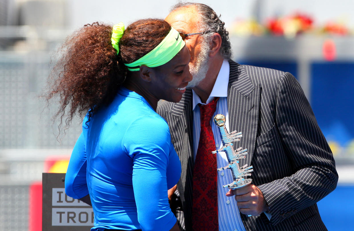 Serena Williams of USA receives a kiss and the trophy from Ion Tiriac in Madrid (Photo by AMA/Corbis via Getty Images)