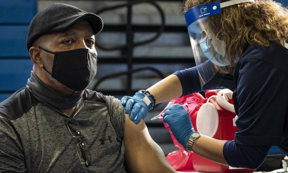 Rafi Peterson, 63, receives the first dose of the Pfizer-BioNTech vaccine in Chicago on Thursday.