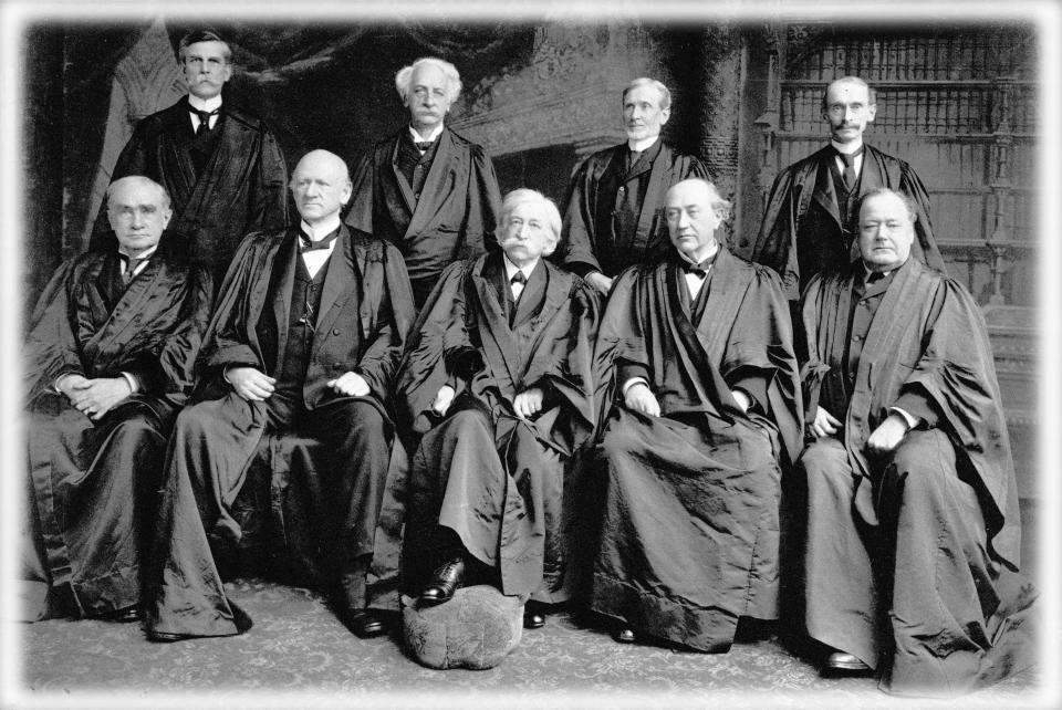 1904:  Members of the US Supreme Court Justice Oliver Wendell Holmes (1841 - 1935), Justice Peckham, Joseph McKenna (1843 - 1926), William Rufus Day (1849 - 1923), Henry Billings Brown (1836 - 1913), John Marshall Harlan (1833 - 1911), Melville Weston Fuller (1833 - 1910), David Josiah Brewer (1837 - 1910) and Edward Douglass White (1845 - 1921).  (Photo: MPI/Getty Images, digitally enhanced by Yahoo News)