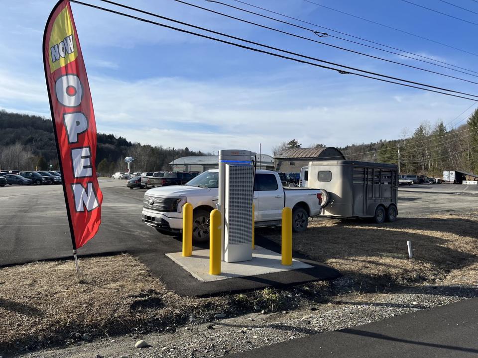 ford lightning with trailer at a charger