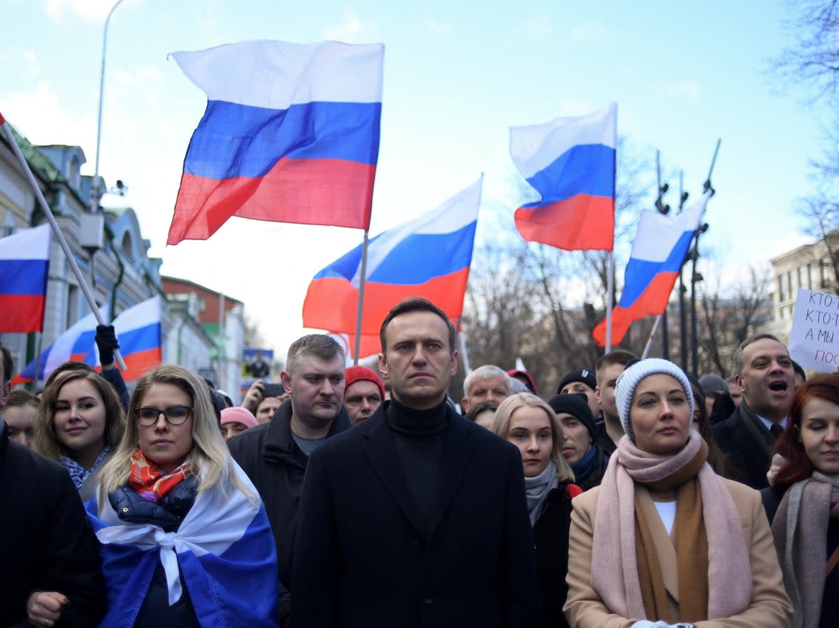 Alexei Navalny and his wife Yulia join a march in memory of murdered Kremlin critic Boris Nemtsov, in Moscow, on 29 February 2020 (AFP/Getty)