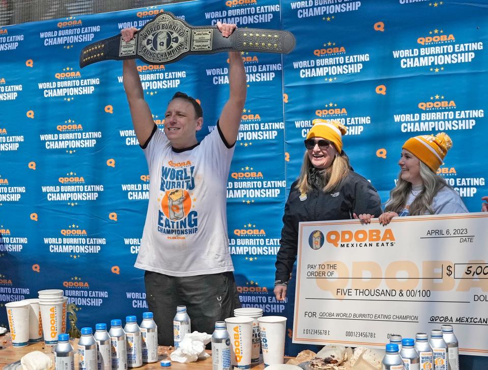 World Champion competitive eater Joey Chestnut reacts to winning the World Burrito Eating Contest with Qdoba representatives at the Beer Garden in Deer District in Milwaukee on Thursday.