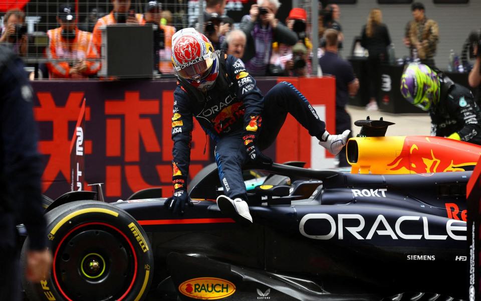 Verstappen gets out of his car as he celebrates after winning the sprint