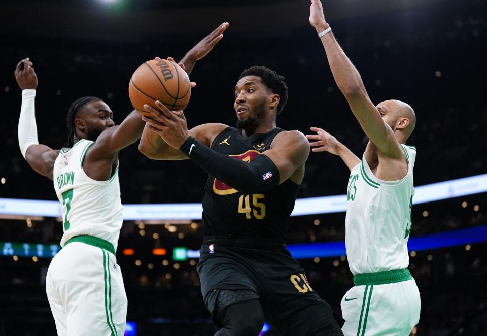 Cavaliers guard Donovan Mitchell passes the ball as Celtics guards Jaylen Brown (7) and Derrick White (9) defend in the first quarter during Game 2 of the Eastern Conference semifinals, May 9, 2024, in Boston.