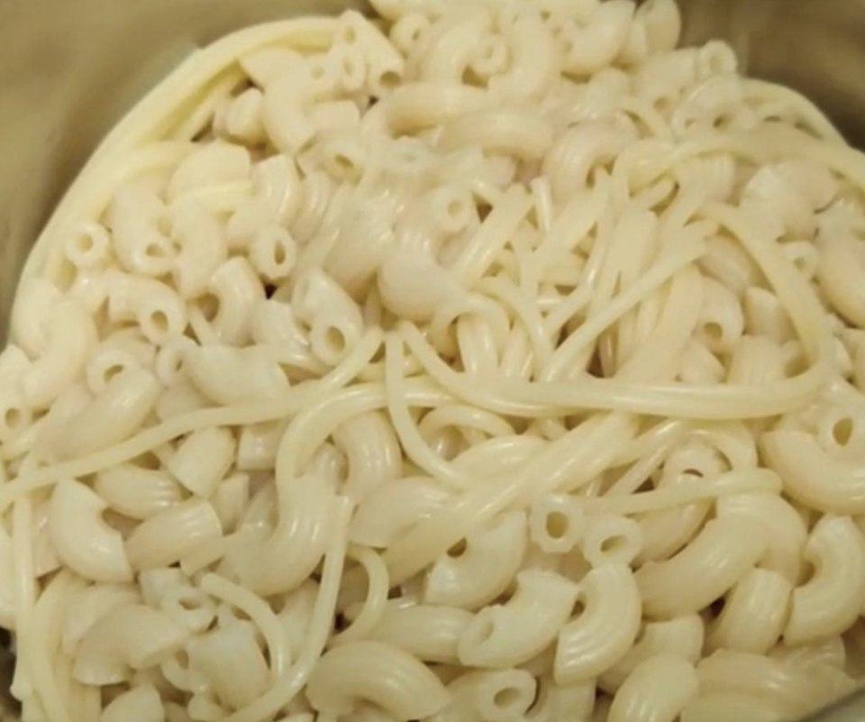 A bowl with multiple different kids of pasta mixed together