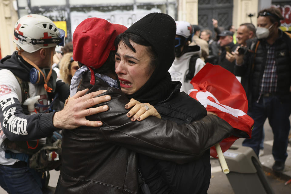 A protester cries after seeing other protesters being detained during the May Day demonstration, Wednesday, May 1, 2024 in Paris. Thousands of protesters marched through the French capital, seeking better pay and working conditions. Pro-Palestinian groups and anti-Olympics activists joined the rally in Paris which will host the Summer Games in less than three months. (AP Photo/Thomas Padilla)