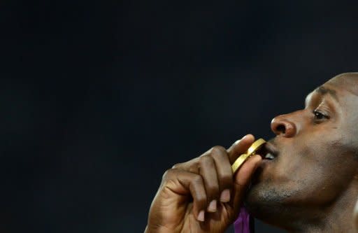 Gold medallist Jamaica's Usain Bolt kisses his medal on the podium after the men's 200m final at the athletics event during the London 2012 Olympic Games in London