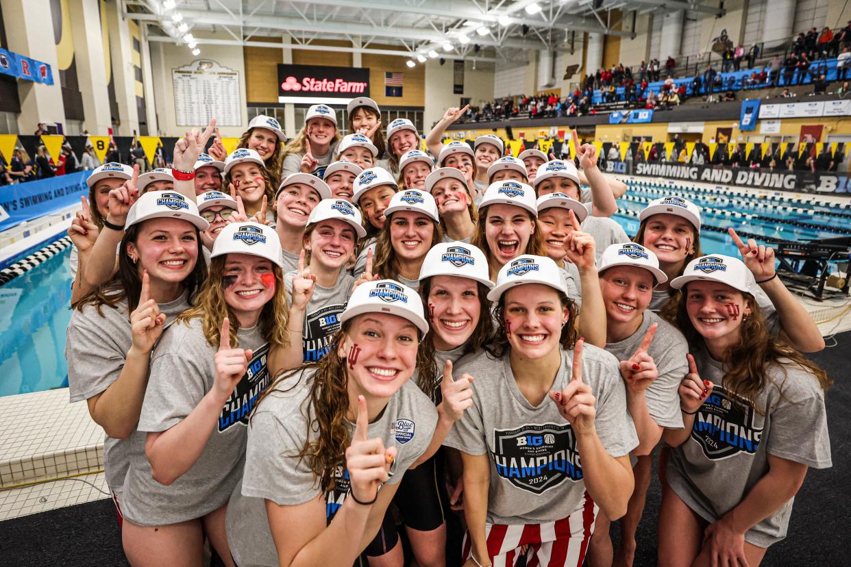 The Indiana women's swimming and diving team celebrates winning the 2024 Big Ten championship.