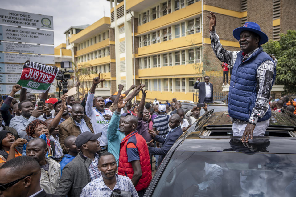 Presidential candidate Raila Odinga waves to supporters as he leaves the Supreme Court in Nairobi, Kenya Monday, Aug. 22, 2022. Odinga filed a Supreme Court challenge to last week's election result, asserting that the process was marked by criminal subversion and seeking that the outcome be nullified and a new vote be ordered. (AP Photo/Ben Curtis)