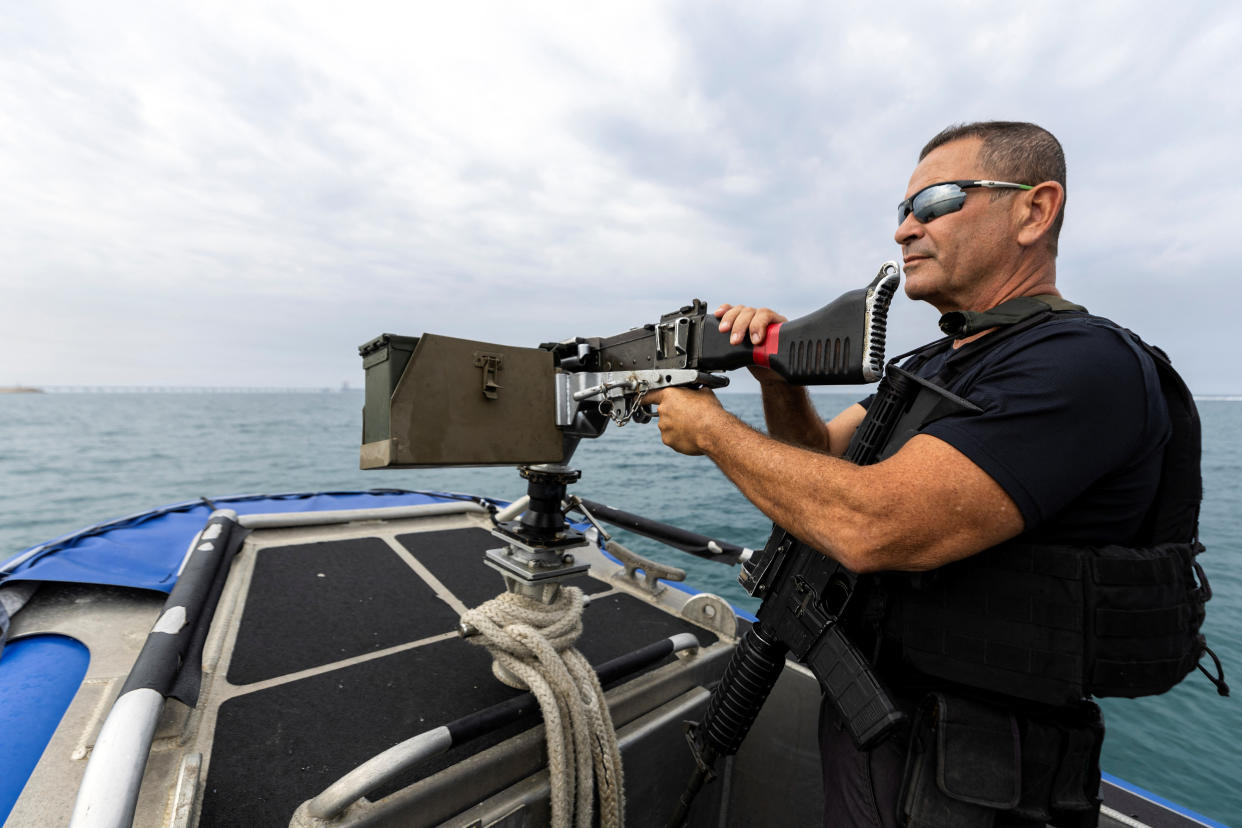 A police officer maneuvers a police patrol boat by a power plant near Israel's maritime border with Gaza in southern Israel October 27, 2023. REUTERS/Amir Cohen