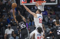 Los Angeles Clippers center Isaiah Hartenstein (55) defends as Sacramento Kings forward Marvin Bagley III (35) shoots during the first quarter of an NBA basketball game in Sacramento, Calif., Saturday, Dec. 4, 2021. (AP Photo/Randall Benton)