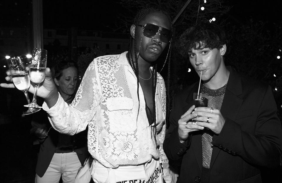 Jeremy O. Harris and Noah Beck catch up at AMI’s cocktail party in Cannes on May 18, 2022. - Credit: Courtesy of AMI