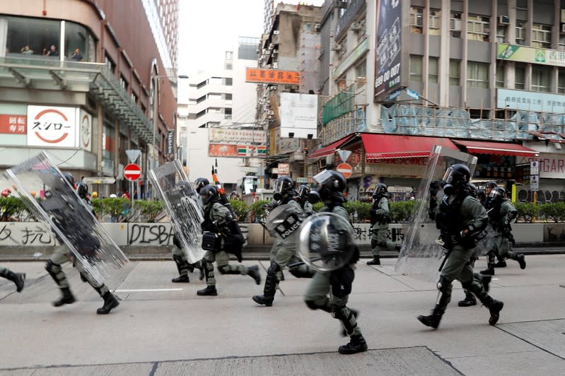 Riot police officers block the street during an anti-government protest in Hong Kong